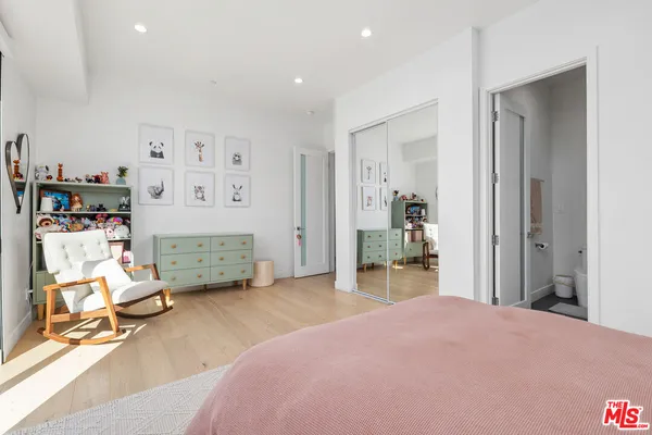 a bedroom with furniture and a large window