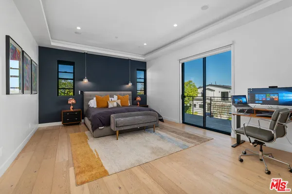 a bedroom with furniture and a chair
