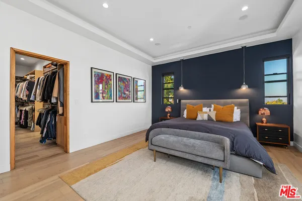 a bedroom with a bed and a walk in closet