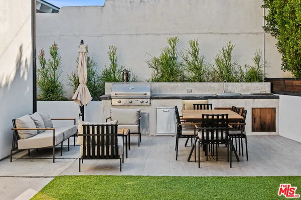 a view of a chairs and table in patio