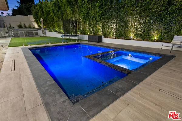 a view of outdoor space with swimming pool and yard