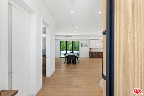 a view of a living room with furniture and floor to ceiling window