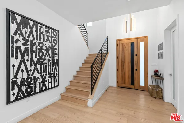 a view of an entryway with wooden floor