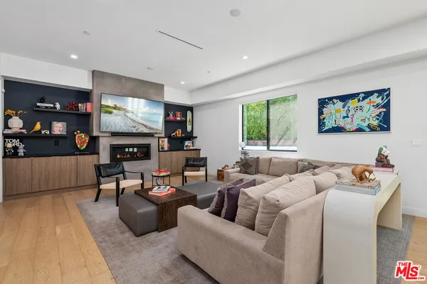 a living room with fireplace furniture and a flat screen tv