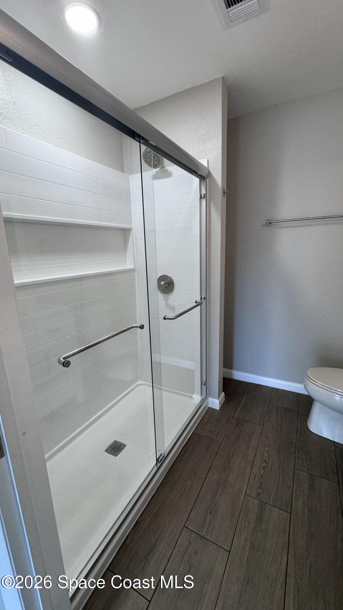2137 Laden Road Melbourne, FL 32935 - Photo 10 of 23 a bathroom with a glass shower door