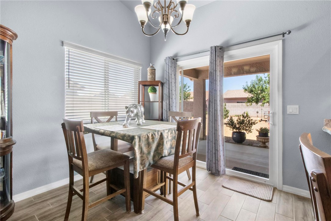 3897 Easy Street Kingman, AZ 86409 - Photo 9 of 53 a dining room with furniture a rug and a chandelier
