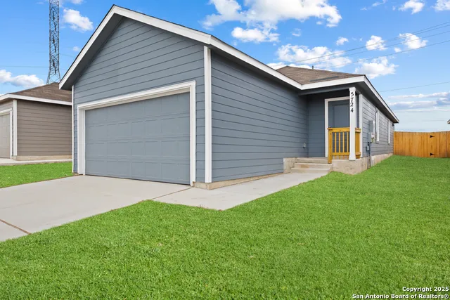 a front view of house with yard and green space