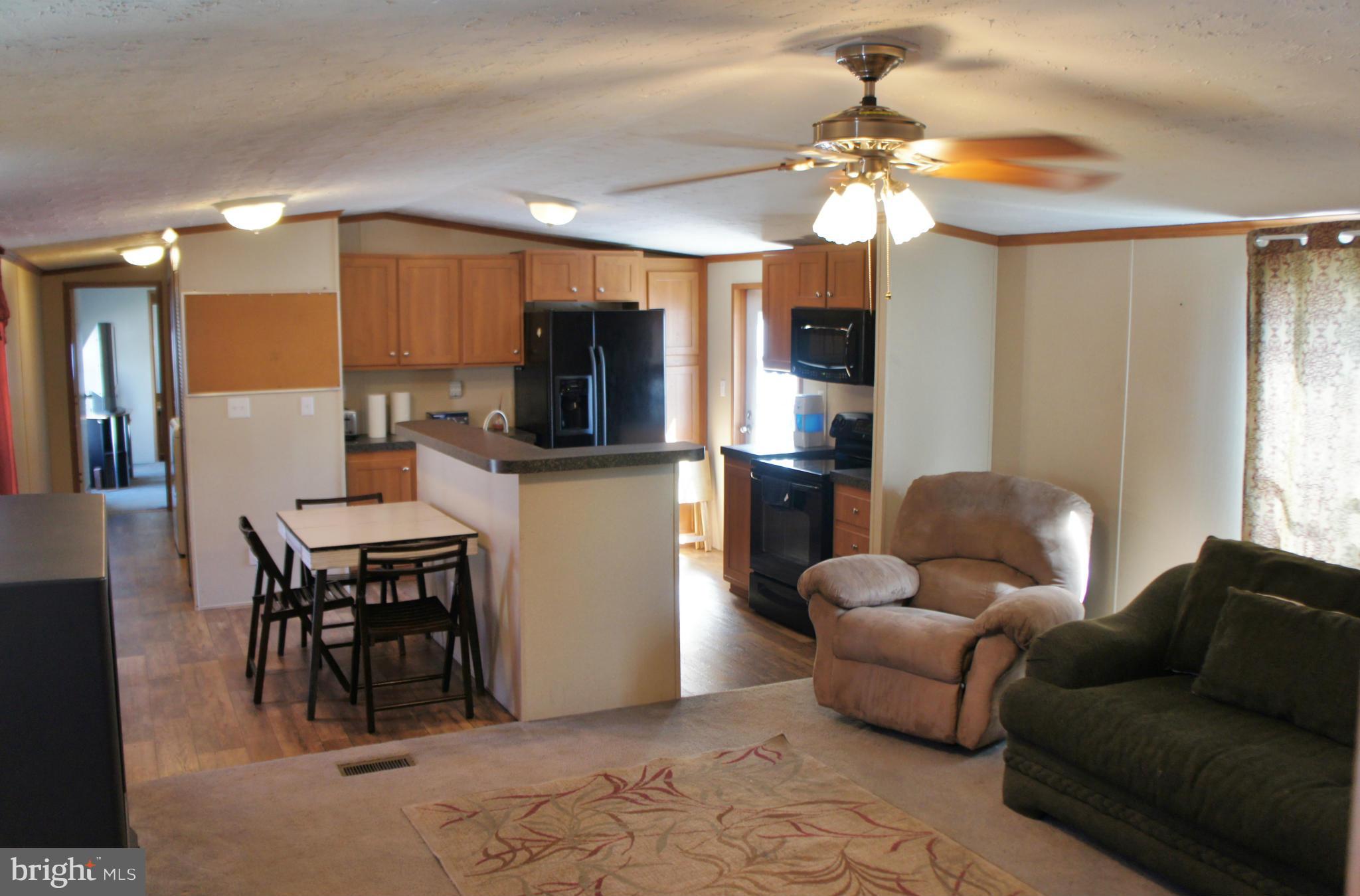 118 German Chapel Road Prince Frederick, MD 20678 - Photo 4 of 27 a living room with furniture a flat screen tv and kitchen view