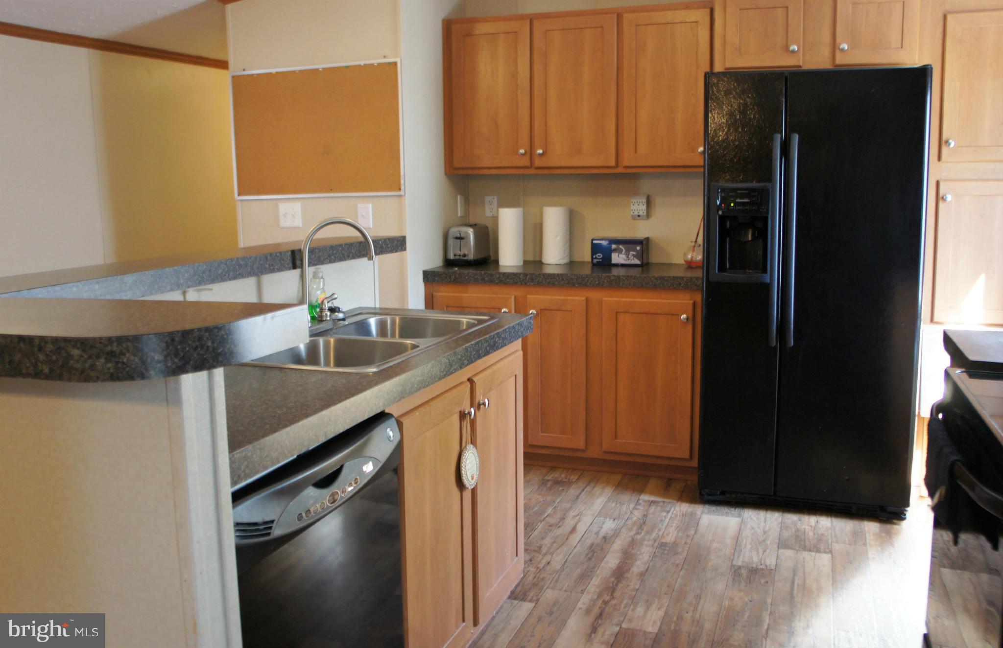 118 German Chapel Road Prince Frederick, MD 20678 - Photo 6 of 27 a kitchen with a sink a refrigerator and a stove