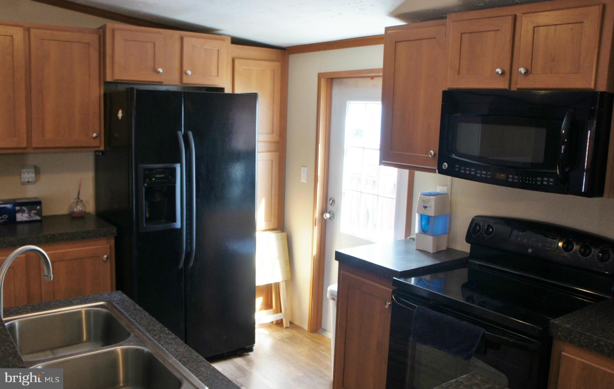 118 German Chapel Road Prince Frederick, MD 20678 - Photo 7 of 27 a kitchen with a refrigerator stove and microwave