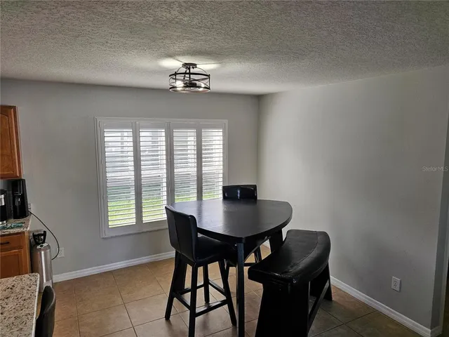 a dining room with furniture and window
