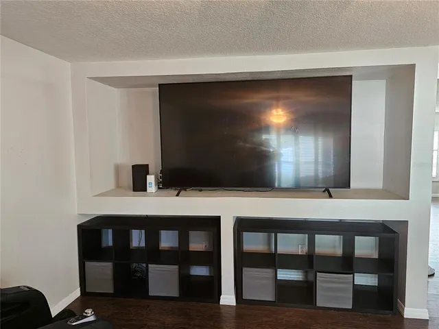 a room with a table chair and a wooden floor