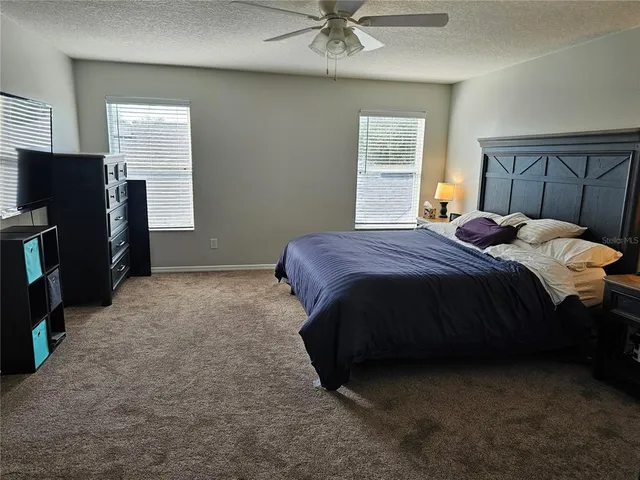 a bedroom with a bed and a television