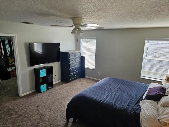 a bedroom with a bed and a television in it