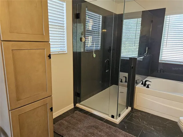 a bathroom with a tub and a shower