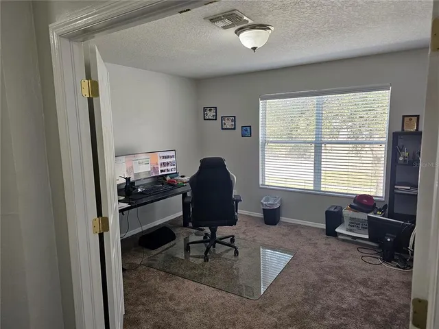 a livingroom with workspace and a window