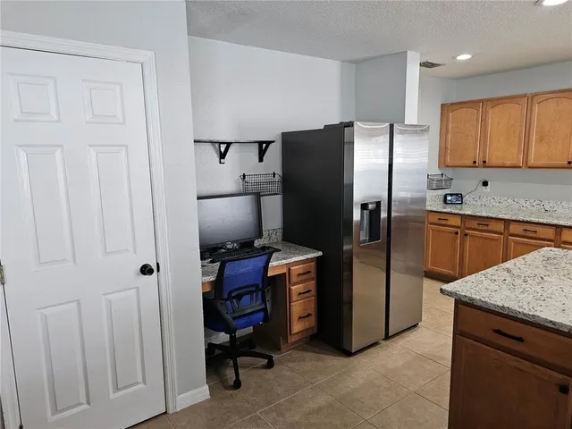 a kitchen with stainless steel appliances granite countertop a refrigerator stove and sink