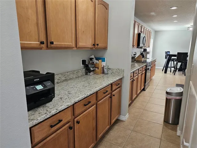 a kitchen with stainless steel appliances granite countertop a sink a stove and a refrigerator