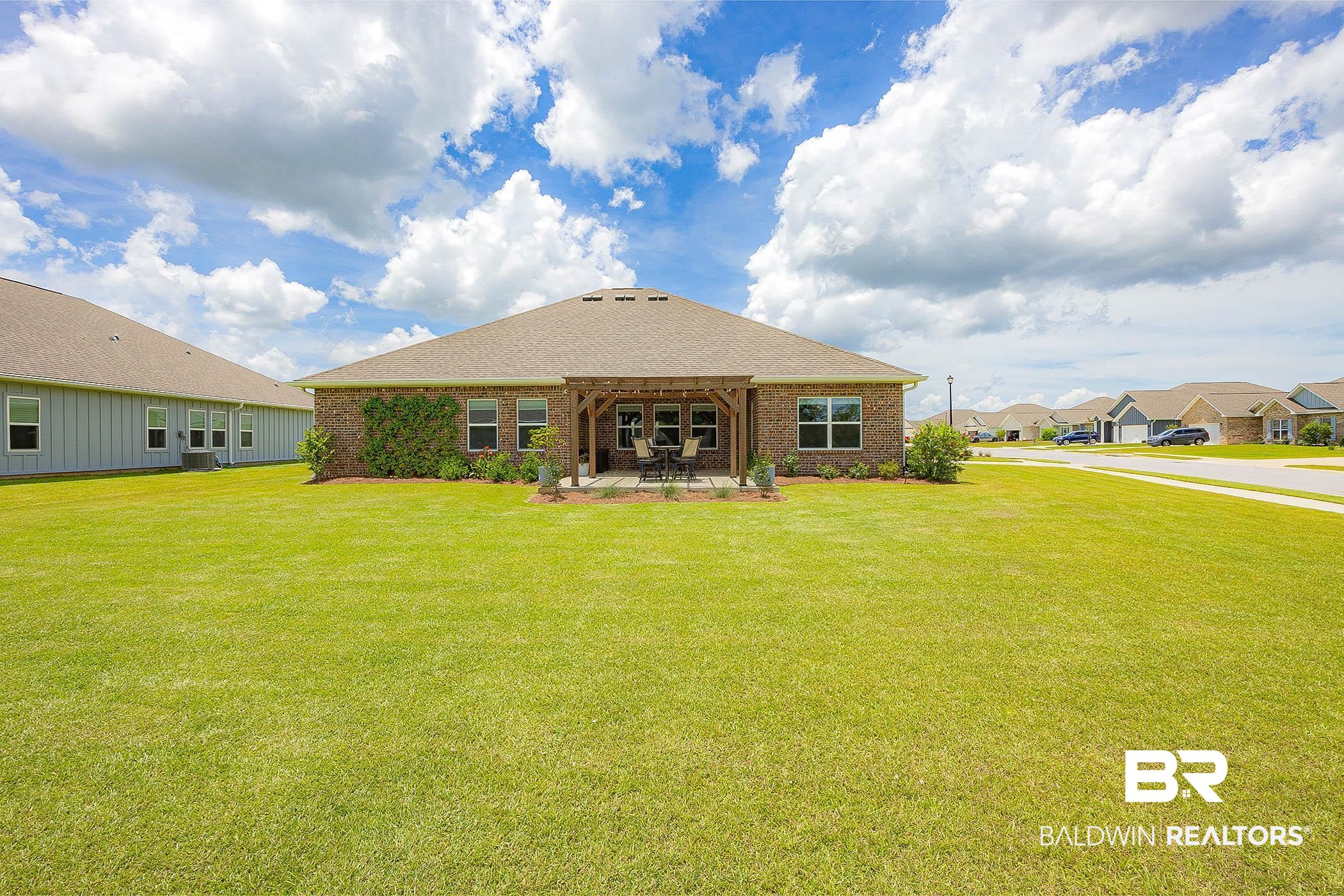 11044 Native Dancer Way Daphne, AL 36526 - Photo 46 of 67 Back of house featuring a lawn and a patio area