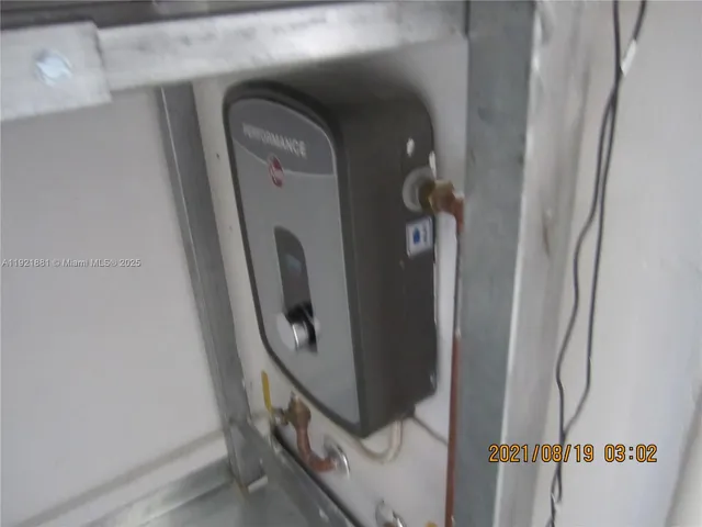 an empty room with wooden floor closet and windows