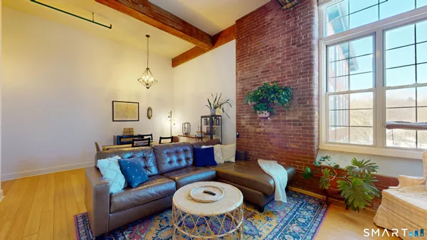 a living room with furniture and a potted plant