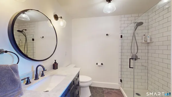 a bathroom with a shower and a sink