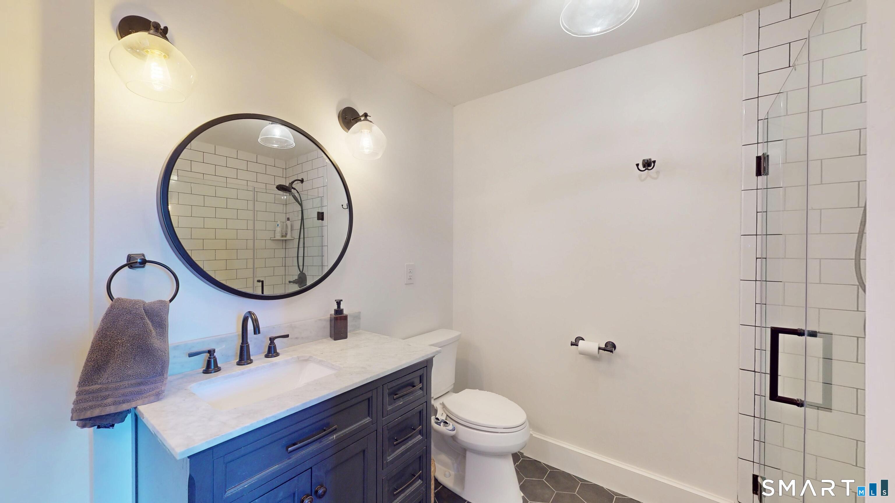 45 Main Street Plainfield, CT 06374 - Photo 17 of 20 a bathroom with a toilet a sink and mirror