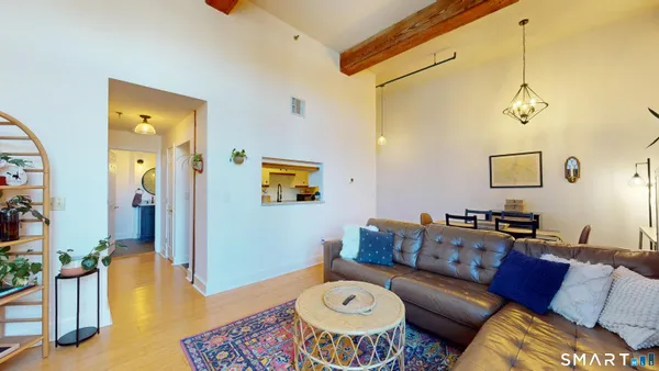 a living room with furniture and a wooden floor
