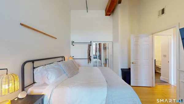 a bedroom with a bed and a table