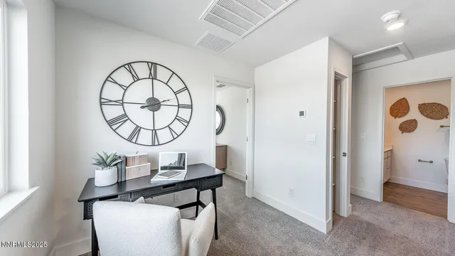 a living room with a table and a mirror