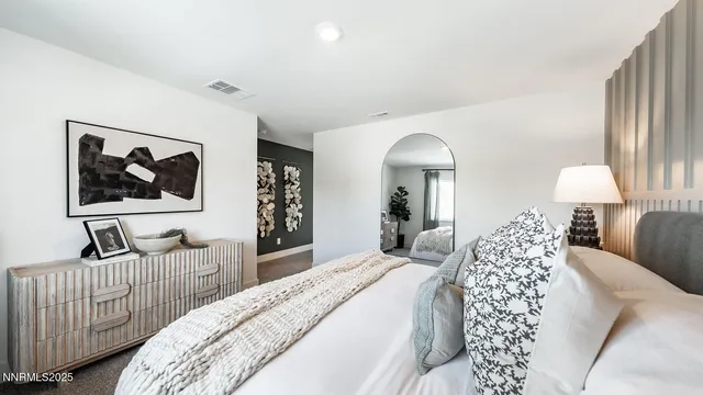 a bedroom with a bed and a lamp