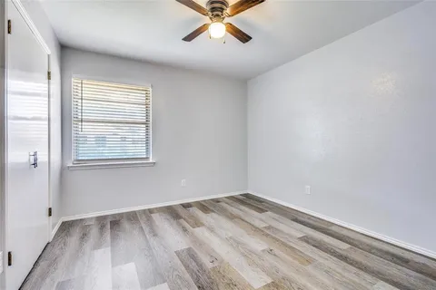 a view of a room with a ceiling fan and a window