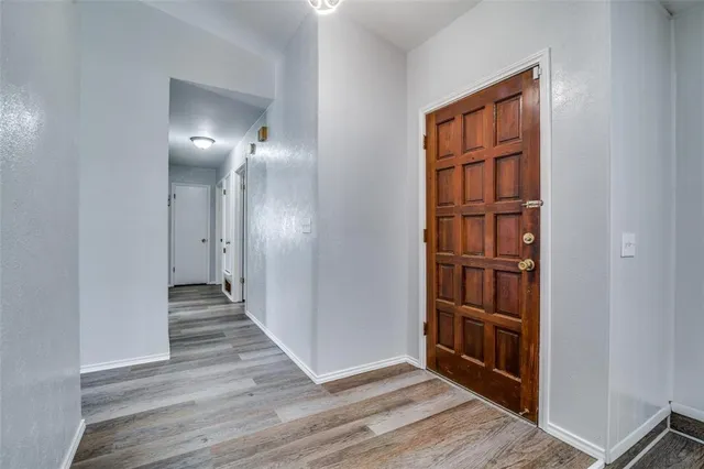 wooden floor in a hall with a window and wooden floor