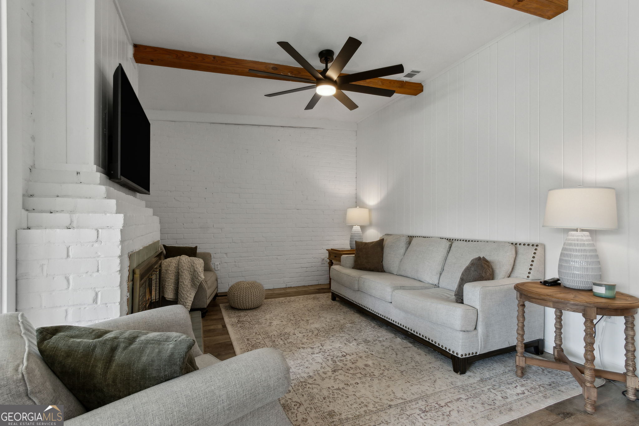 6 Stewart Lane Jekyll Island, GA 31527 - Photo 12 of 95 a living room with furniture and a flat screen tv