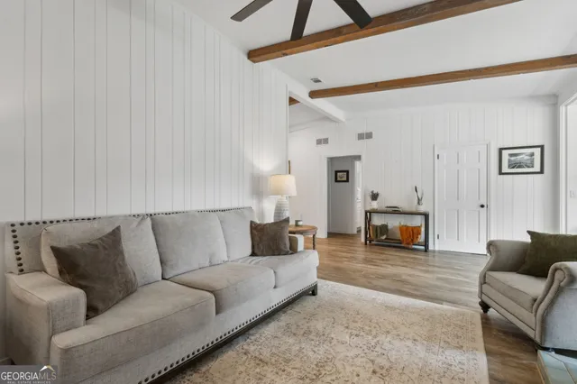 a view of a dining room with furniture large windows and wooden floor