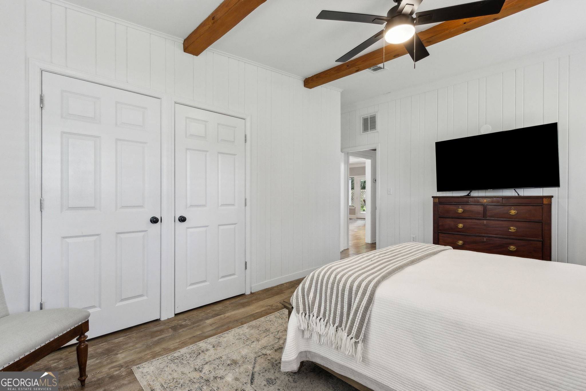 6 Stewart Lane Jekyll Island, GA 31527 - Photo 23 of 95 a bedroom with a bed and a flat screen tv