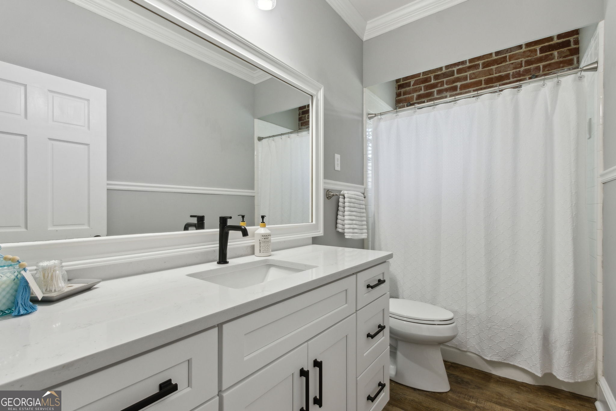6 Stewart Lane Jekyll Island, GA 31527 - Photo 25 of 95 a bathroom with a sink a toilet and a mirror