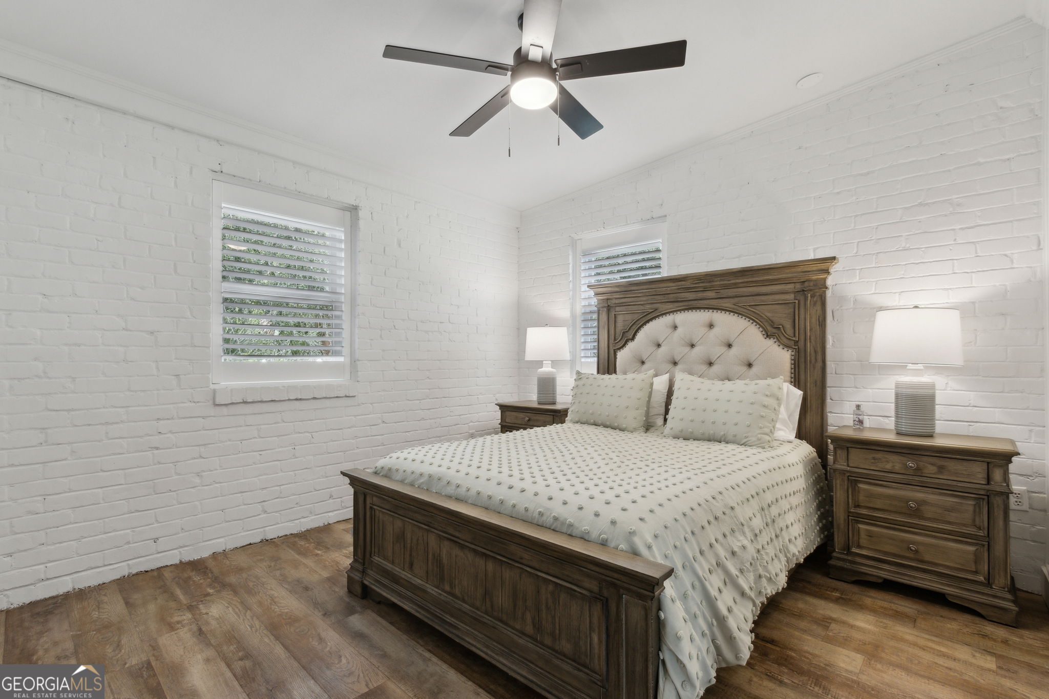6 Stewart Lane Jekyll Island, GA 31527 - Photo 26 of 95 a bedroom with a bed a dresser and a window