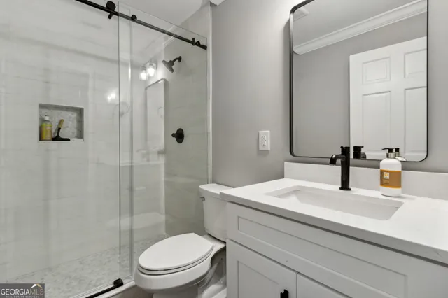 a bathroom with a toilet a sink and a shower