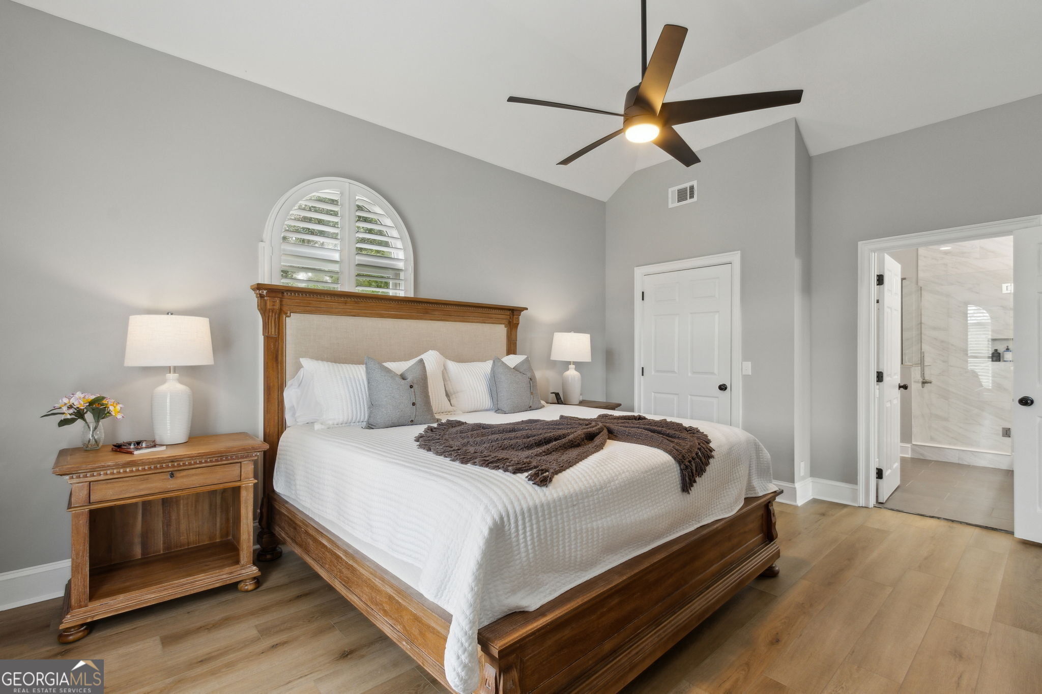 6 Stewart Lane Jekyll Island, GA 31527 - Photo 33 of 95 a bedroom with a bed and a chandelier