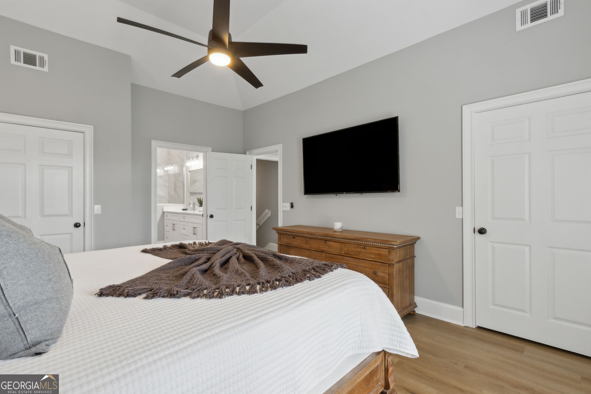 6 Stewart Lane Jekyll Island, GA 31527 - Photo 34 of 95 a bedroom with a bed and a flat screen tv