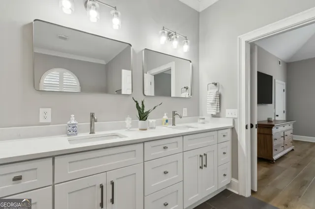 a spacious bathroom with a tub double sink and glass door