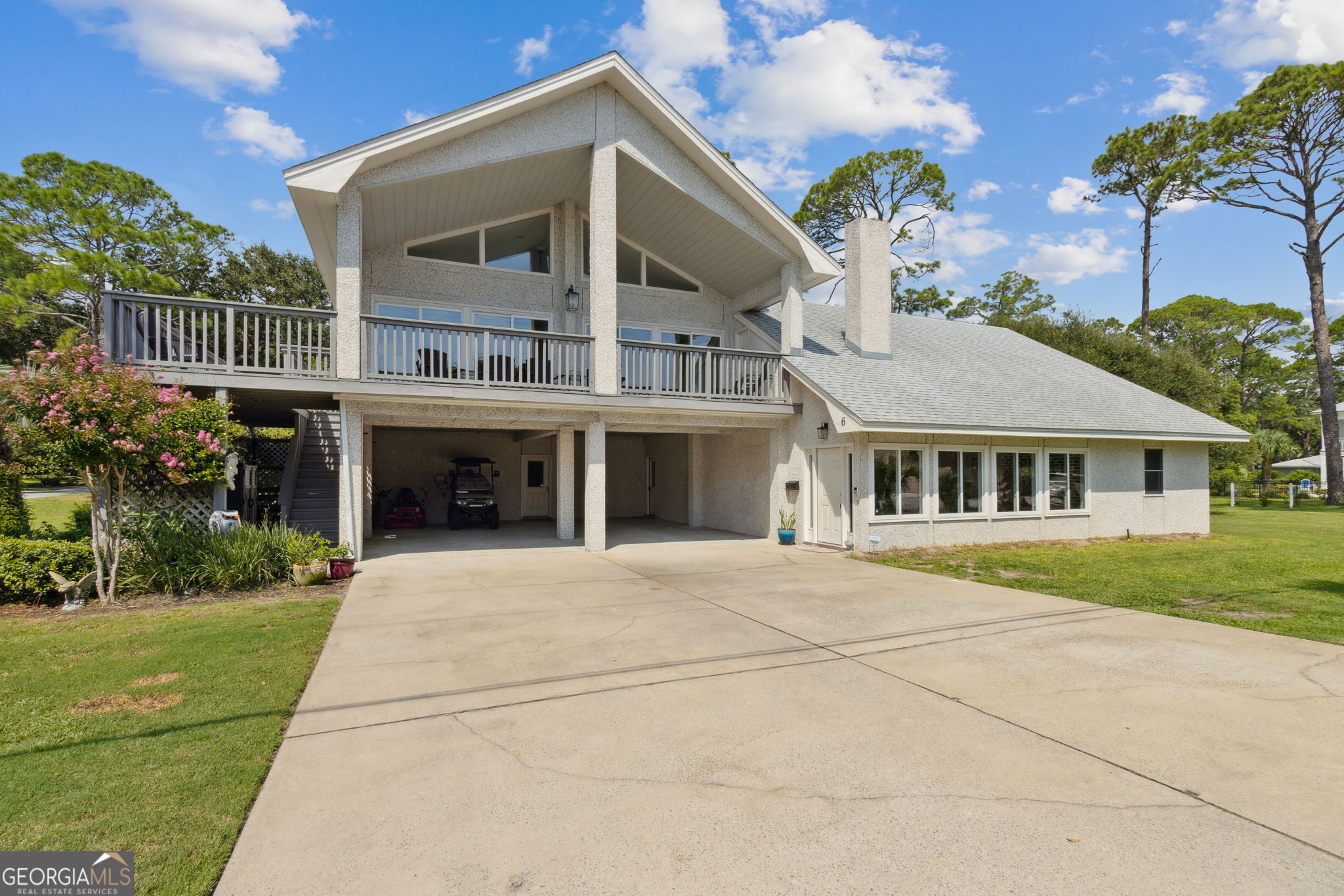 6 Stewart Lane Jekyll Island, GA 31527 - Photo 4 of 95 a front view of a house with a garden
