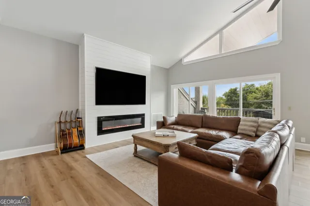a view of a house with a big yard and large tree