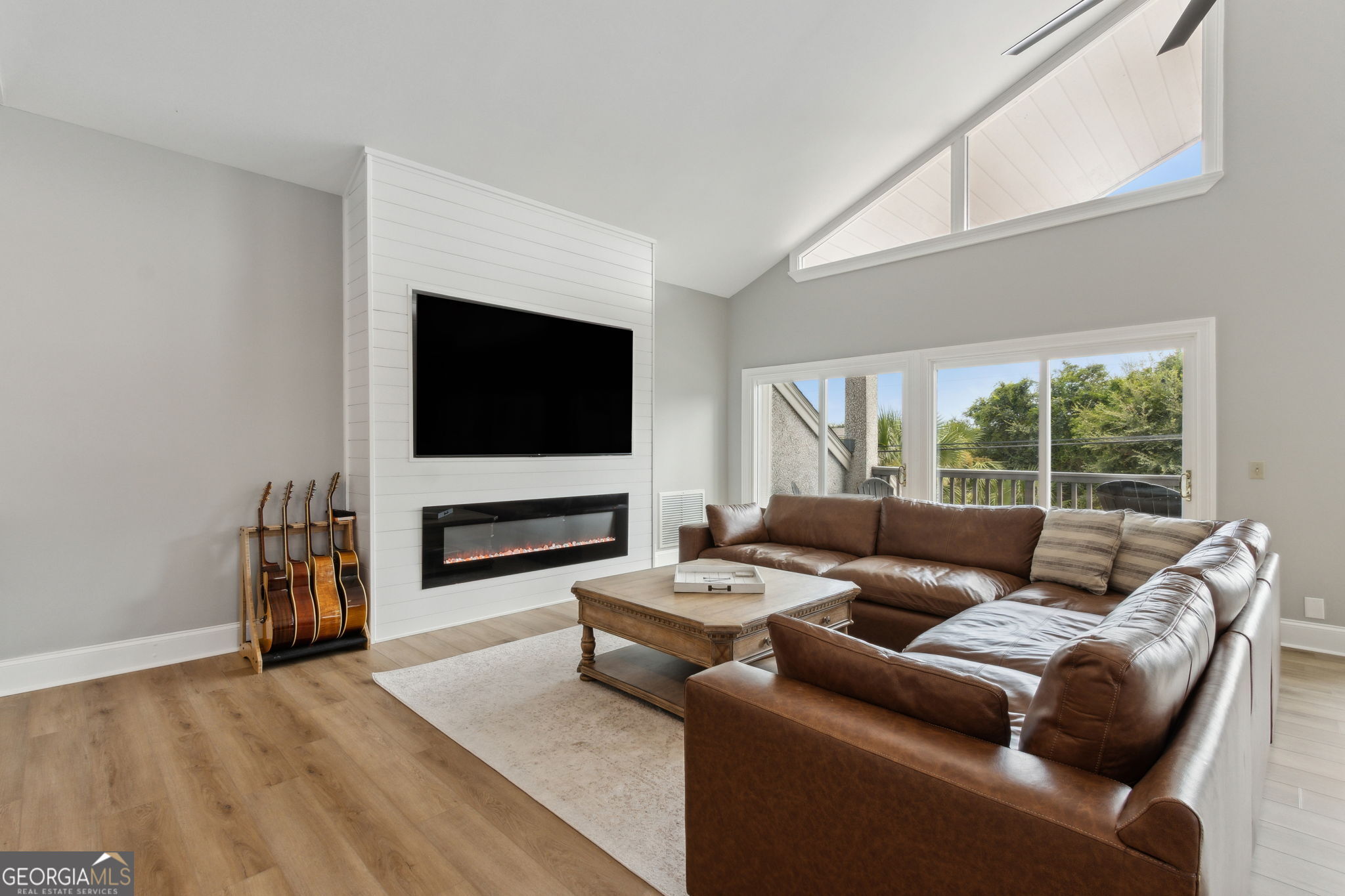 6 Stewart Lane Jekyll Island, GA 31527 - Photo 42 of 95 a living room with furniture and a flat screen tv