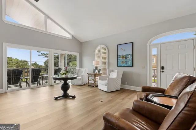 a aerial view of a house with a yard and lake view