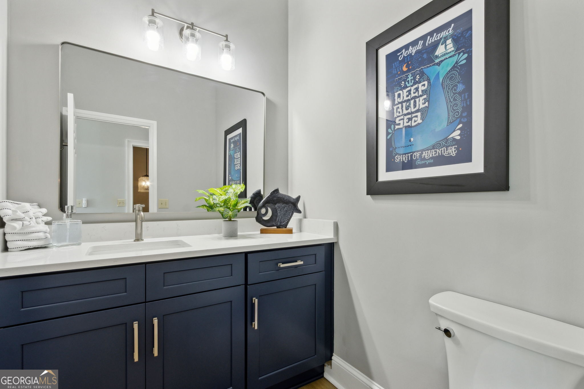 6 Stewart Lane Jekyll Island, GA 31527 - Photo 52 of 95 a bathroom with a sink and a mirror