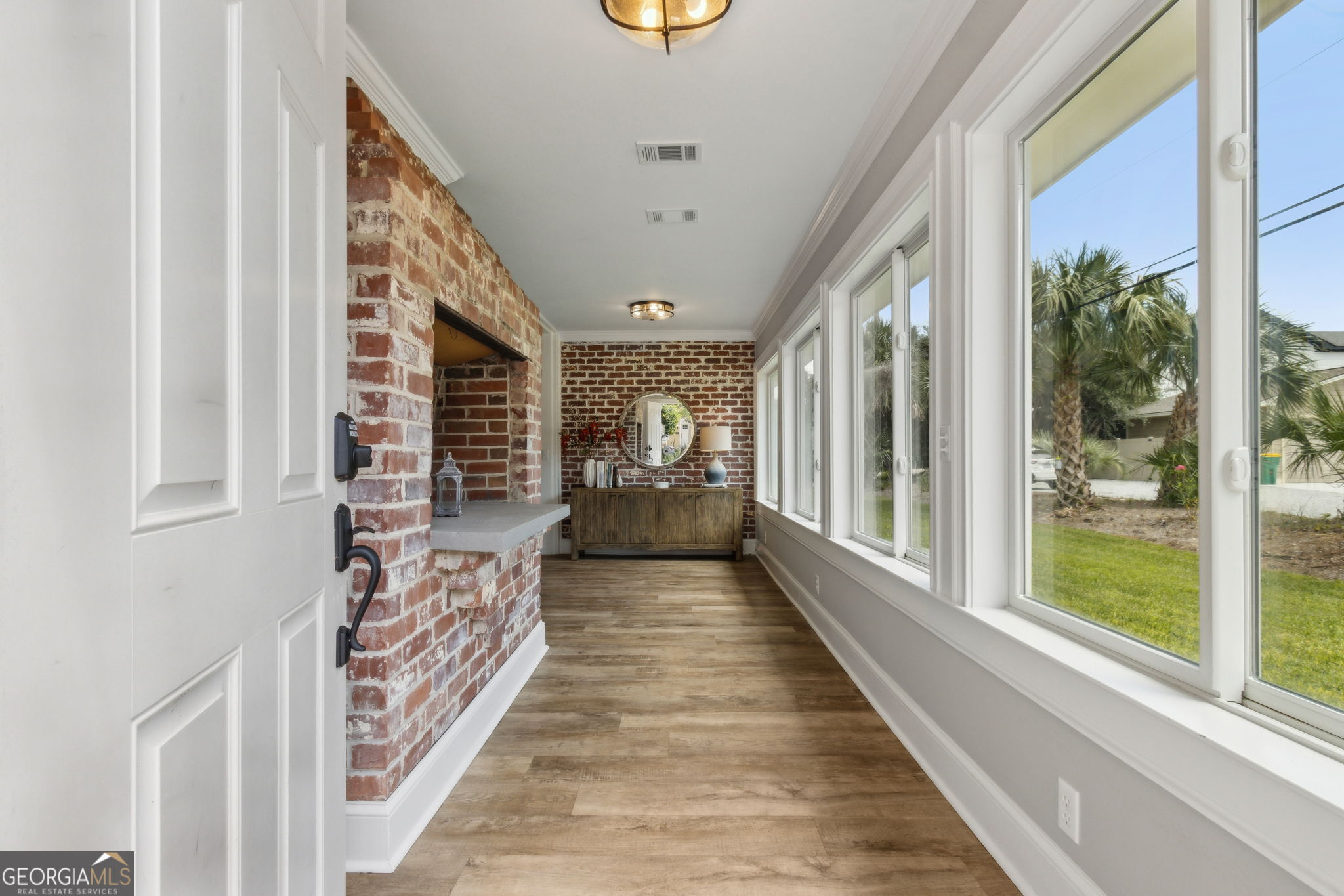 6 Stewart Lane Jekyll Island, GA 31527 - Photo 6 of 95 a view of a hallway with wooden floor and staircase