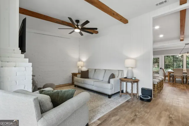 a living room with furniture white wall and a fireplace