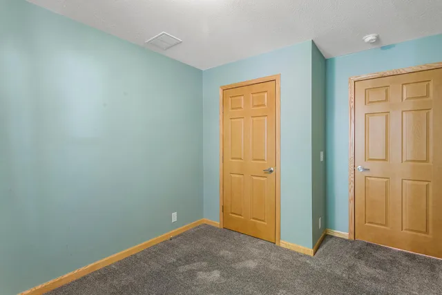 an empty room with closet area